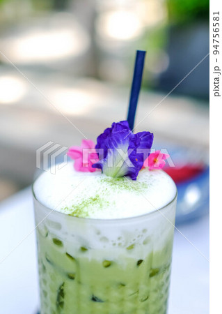 Iced Matcha latte tea with a blur background. 94756581