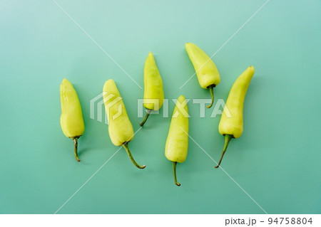 green peppers on the green background 94758804