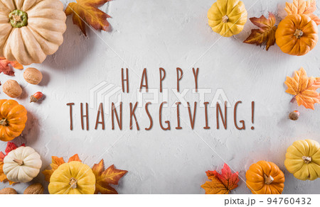 Thanksgiving and autumn decoration concept. Pumpkin, autumn leaves and apple with the text on stone background. 94760432