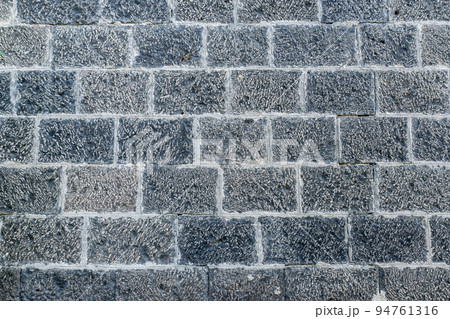 Light gray, white bricks on the wall decoration for background. Stone brick wall textures. 94761316