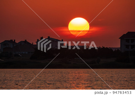 The sun goes down over a lake The sun goes down over a lake 94763453