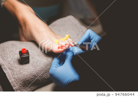 Master does pedicure for client. Pedicure process. Girl draws toenails. Master does pedicure for client. Pedicure process. Girl draws toenails. 94766044