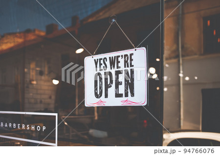 Open sign on the black glass in shop. Open sign on the black glass in shop. 94766076