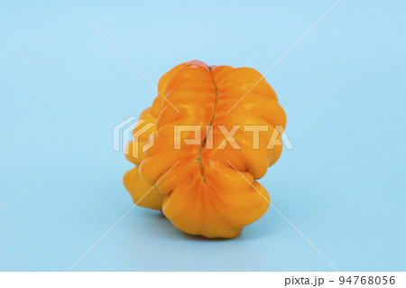 Ugly vegetables concept. Tomatoes of various unusual shapes on a blue minimal background. A metaphor for imperfection, the female body, the art of photography and form. 94768056