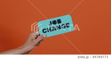 holds a sign with the text job change 94769773