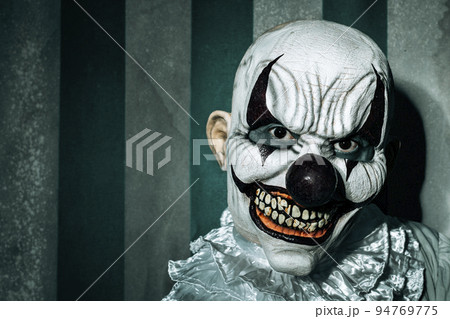 creepy evil clown in an old circus creepy evil clown in an old circus 94769775