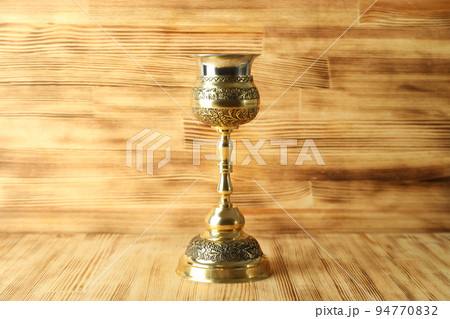 Concept of Eucharist with Chalice on wooden background Concept of Eucharist with Chalice on wooden background 94770832