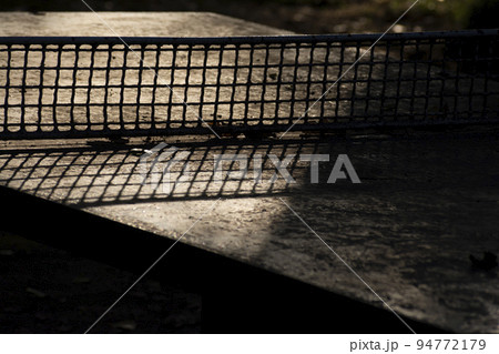 Detail of cement table tennis with harsh sunlight Detail of cement table tennis with harsh sunlight 94772179