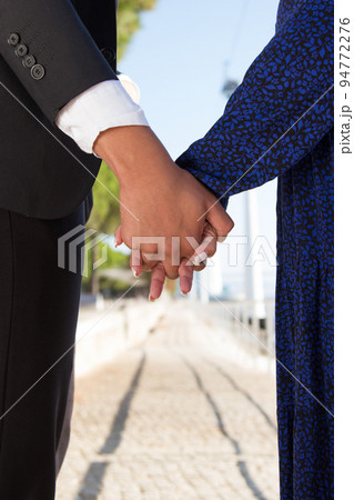 Close-up of man and woman holding hands 94772276