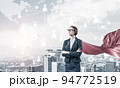 Concept of power and sucess with businesswoman superhero in big city 94772519