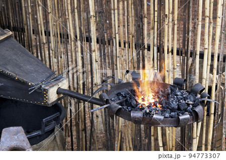 Blacksmith forge in the open air. traditional work. Blacksmith forge in the open air. traditional work. 94773307