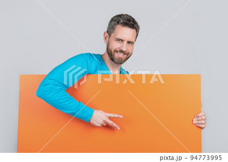 man behind blank paper banner with copy space for advertisement show peace gesture, announcing. 94773995