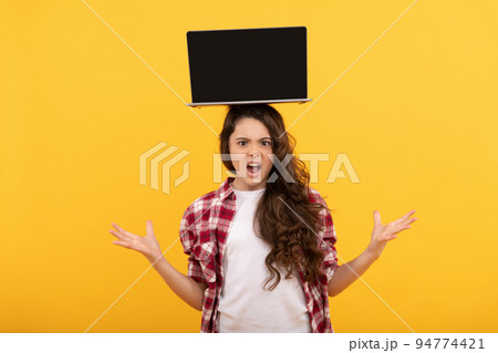 unhappy smart child with laptop on head presenting school online lesson, online education unhappy smart child with laptop on head presenting school online lesson, online education 94774421