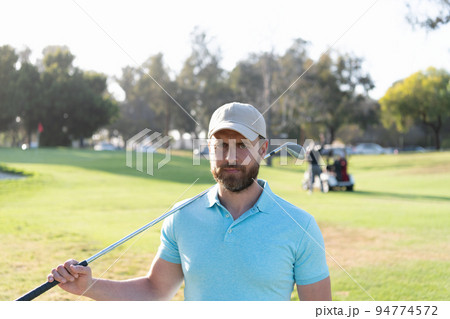 man gold player in cap with golf stick on summer green grass, golfing 94774572
