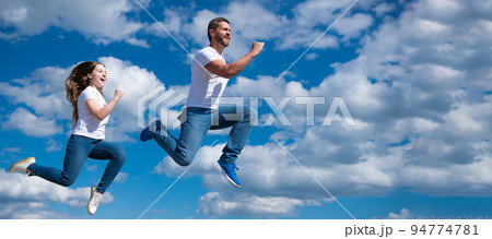 Father and daughter jump on sky, banner with copy space. father and daughter jump high. hurry up. happy childhood and fatherhood. concept of friendship Father and daughter jump on sky, banner with copy space. father and daughter jump high. hurry up. happy childhood and fatherhood. concept of friendship 94774781