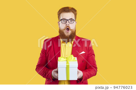 Funny chubby redhead bearded young man in red jacket and glasses gets amazing present Funny chubby redhead bearded young man in red jacket and glasses gets amazing present 94776023