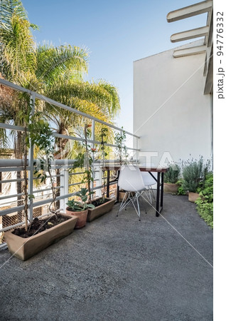 Garden chairs and table in a relaxing, serene, peaceful, lush and private home backyard in summer. 94776332