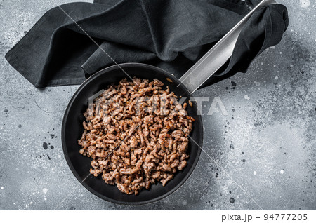 Pan fried minced meat to Italian pasta. Gray background. Top view 94777205