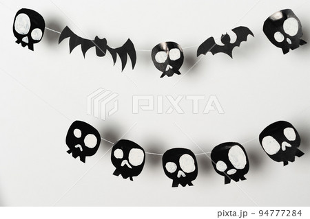 Bats and skulls black on white background, place to write greeting. Bats and skulls black on white background, place to write greeting. 94777284