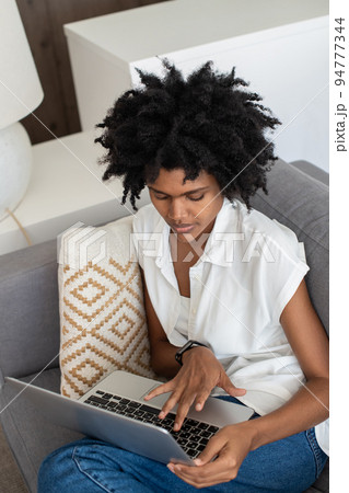 Concentrated woman working from home, typing on laptop 94777344