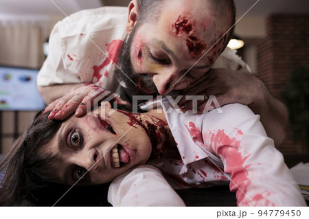 Portrait of evil terrifying zombies at desk, attacking people in office and having bloody scars. Dangerous cruel monsters walking dead and eating brain, horrific possessed walkers hunting. 94779450