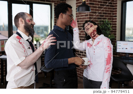 Creepy evil monsters attacking scared man in business office, aggressive dangerous zombies corpses chasing person being frightened. Brain eating devil group acting cruel and bloodthirsty. 94779451