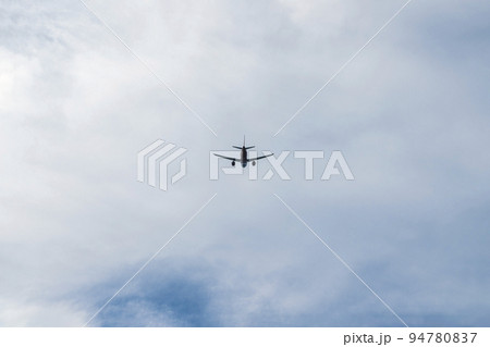 the plane is flying against the blue sky 94780837
