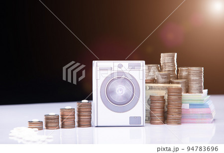 Drug Cartel change and clean money through washing machine or laundering tax system. It is illegal crime and be punished by law lawyer and authority. Concept fraud laundering money, Studio copy space Drug Cartel change and clean money through washing machine or laundering tax system. It is illegal crime and be punished by law lawyer and authority. Concept fraud laundering money, Studio copy space 94783696