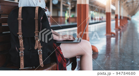 Image of Young asian freelance working at train station before travel. summer work and travel concept Image of Young asian freelance working at train station before travel. summer work and travel concept 94784680