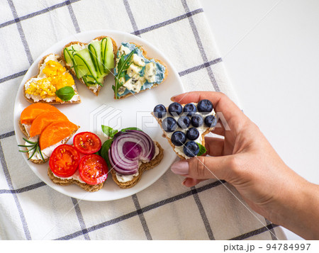 Rainbow sandwiches heart shape on white table 94784997