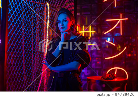 Caucasian woman posing in neon studio. Caucasian woman posing in neon studio. 94789426