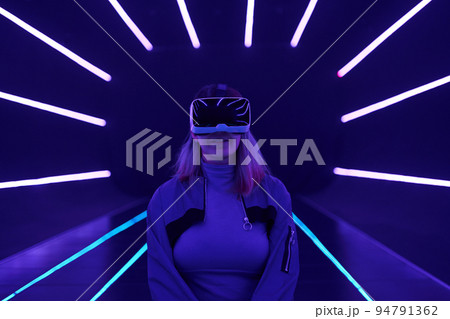 Woman is using virtual reality headset to access in metaverse. Woman is using virtual reality headset to access in metaverse. 94791362