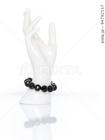Black Spinel bracelet on plastic mannequin female hand. Collection of natural gemstones accessories. Studio shot Black Spinel bracelet on plastic mannequin female hand. Collection of natural gemstones accessories. Studio shot 94792537