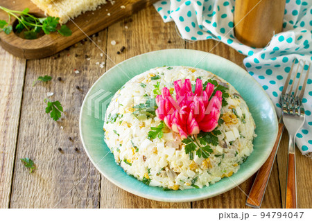 Festive snack on Easter table. Salad with Rice, Onion, Egg, Corn and Mushrooms on table. Copy space. 94794047