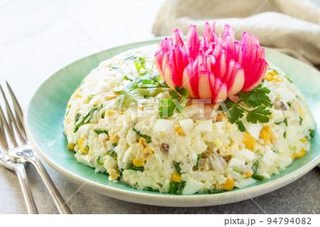 Festive Salad with Rice, Onion, Egg, Corn and Mushrooms on a gray stone or concrete table. Festive Salad with Rice, Onion, Egg, Corn and Mushrooms on a gray stone or concrete table. 94794082