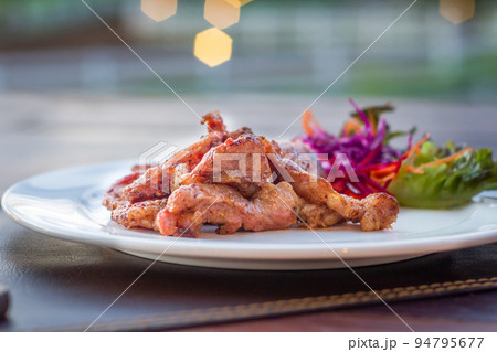 Fried sun dried pork style thai food on white plate Fried sun dried pork style thai food on white plate 94795677