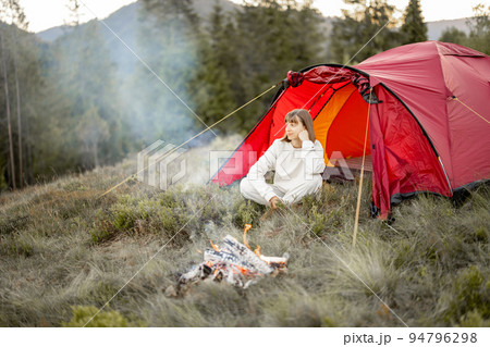 Young woman enjoys nature while travel in the mountains Young woman enjoys nature while travel in the mountains 94796298
