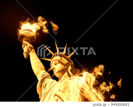 Statue of Liberty with burning fire isolated on black background Statue of Liberty with burning fire isolated on black background 94800881