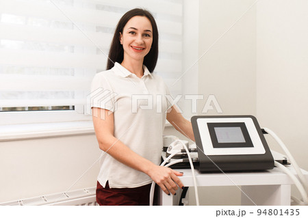 Doctor cosmetologist holds in his hands a device for vacuum anti-cellulite massage 94801435