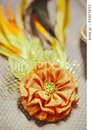 Decirative brooch with feathers for Mardi Gras or carnivale mask and beads on golden background. Party invitation, greeting card, venetian carnivale celebration concept. Decirative brooch with feathers for Mardi Gras or carnivale mask and beads on golden background. Party invitation, greeting card, venetian carnivale celebration concept. 94803653