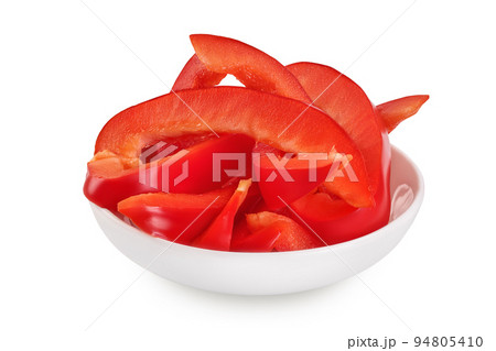 slices of red sweet bell pepper in ceramic bowl isolated on white background 94805410