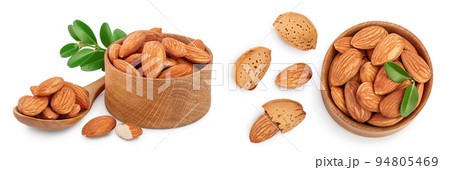 Almonds nuts with leaves in wooden bowl isolated on white background with full depth of field. Almonds nuts with leaves in wooden bowl isolated on white background with full depth of field. 94805469
