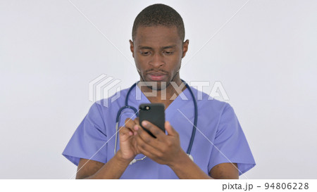 African Doctor Browsing Smartphone on White Background African Doctor Browsing Smartphone on White Background 94806228