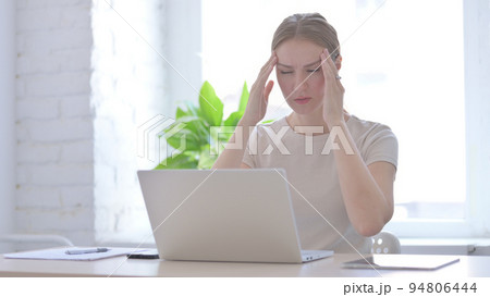 Woman having Headache while Working on Laptop Woman having Headache while Working on Laptop 94806444
