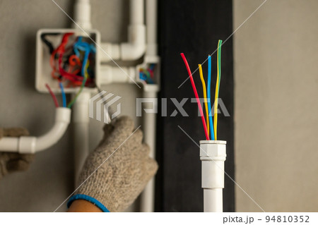Electrician repair wire in PVC Conduit , renovate home . 94810352