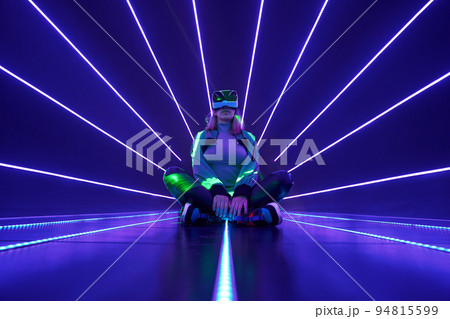 Woman is using virtual reality headset to access in metaverse. Woman is using virtual reality headset to access in metaverse. 94815599