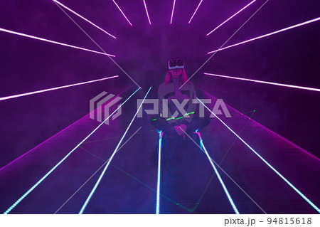 Woman is using virtual reality headset to access in metaverse. 94815618