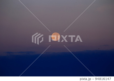 沈んでいく満月と山 94816147