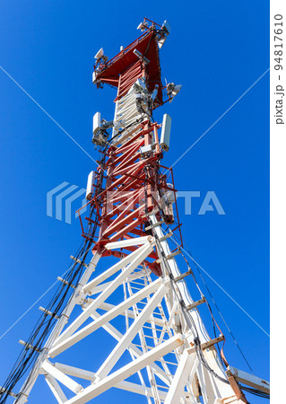 Red white telecommunication tower with radio devices Red white telecommunication tower with radio devices 94817610