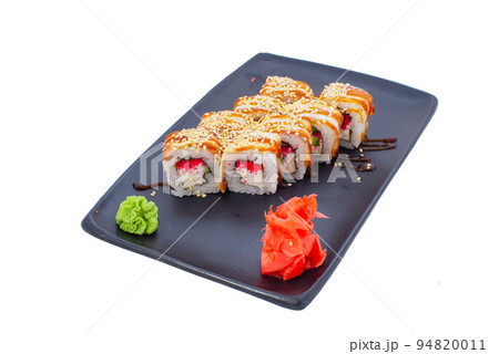 Japanese seafood Sushi roll isolated on white close up. Japanese food restaurant, sushi maki gunkan roll plate or platter set. Maki Sushi rolls with salmon and avocado. Sushi isolated at white 94820011